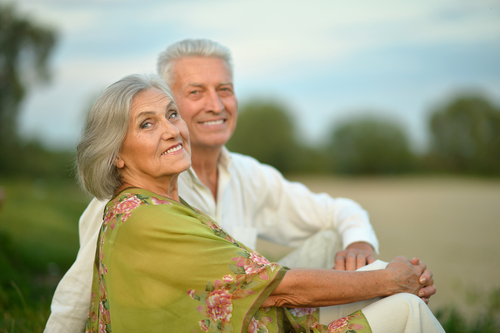 Older couple sitting at beach