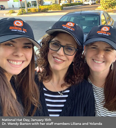 Three women wearing ginsberg hat smiling outdoors