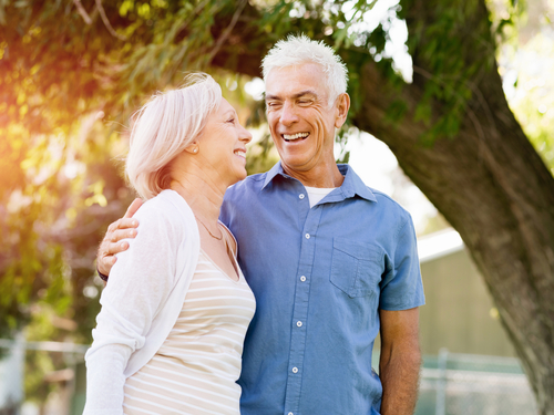 older married couple smiling with each other 