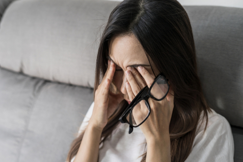 Woman wiping eyes from dry eye