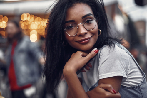 Young woman with glasses smiling before LASIK