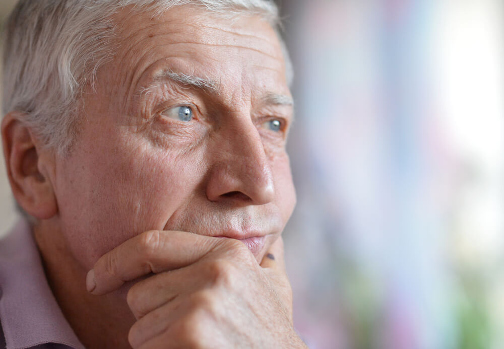 A man holding his chin