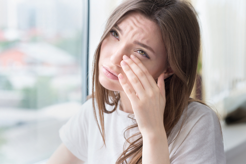 Woman wiping her eyes