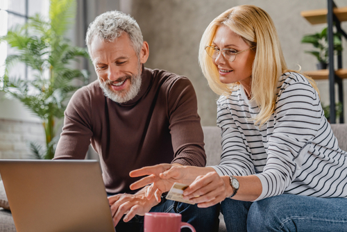 Middle-aged couple shopping on a computer